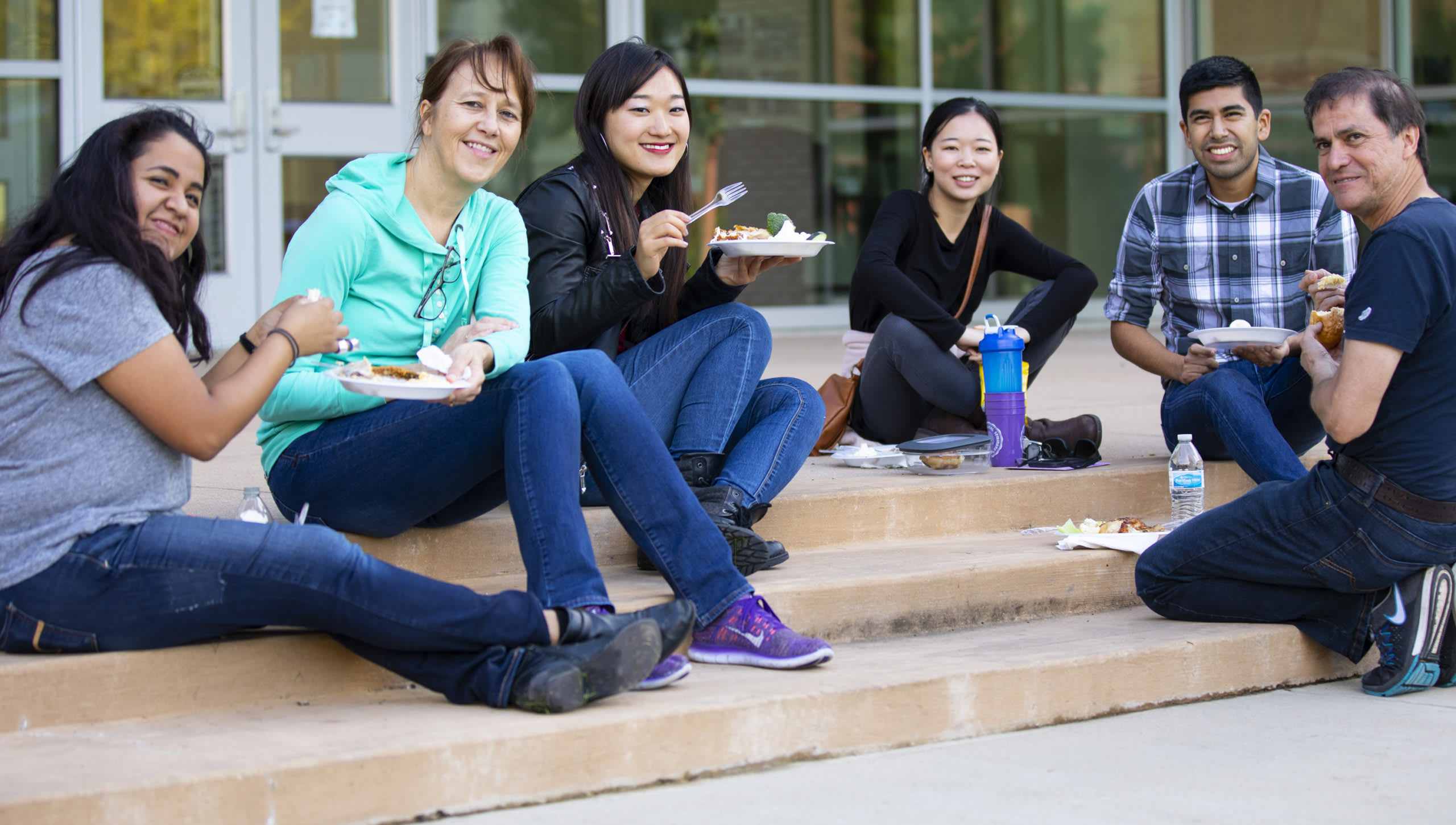 students sitting together outside